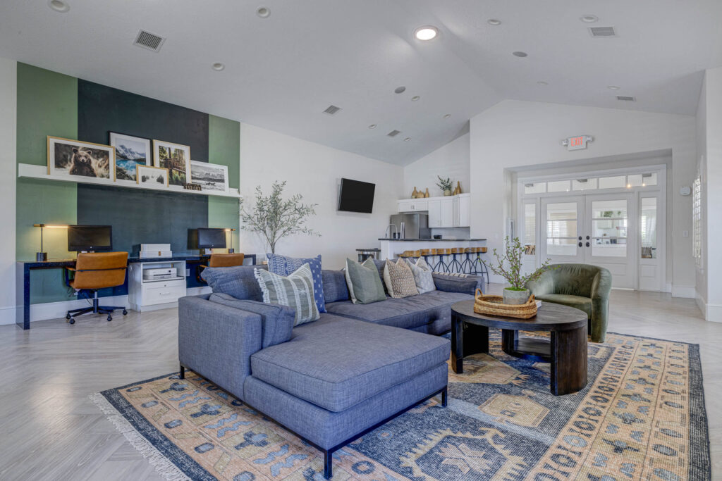 Resident lounge with business center and kitchen at Copperwood apartments in Herriman, Utah.